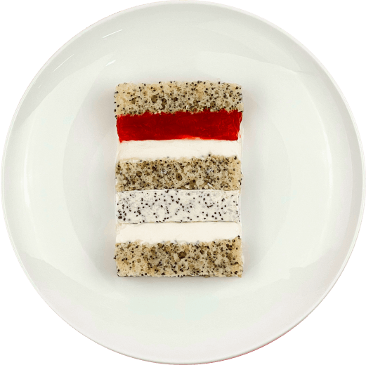 Шматочок торту з двошаровою начинкою мак-полуниця-чизкейк на тарілці.