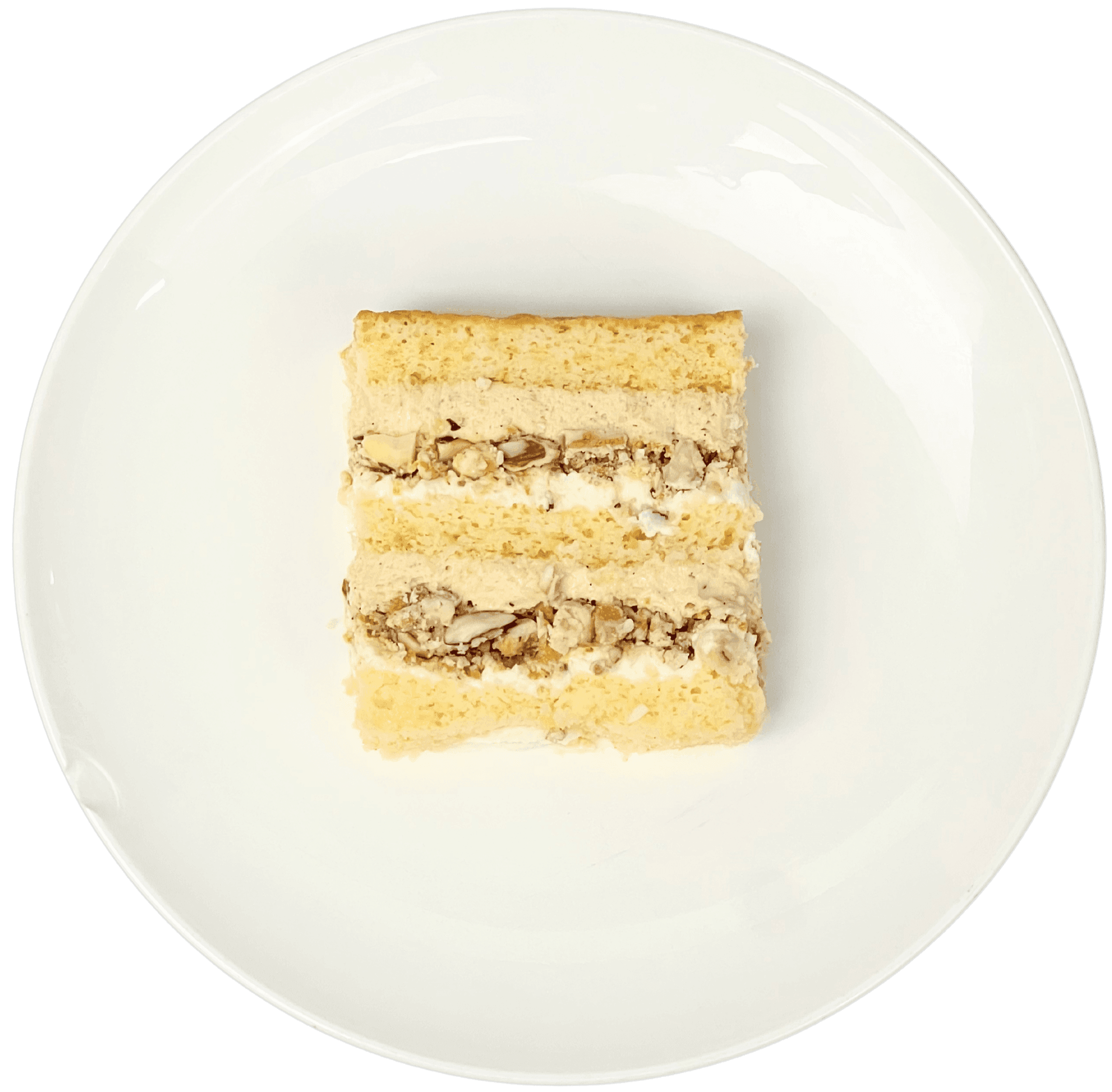 Шматочок торту з двошаровою кокосово-мигдалевою начинкою на тарілці.